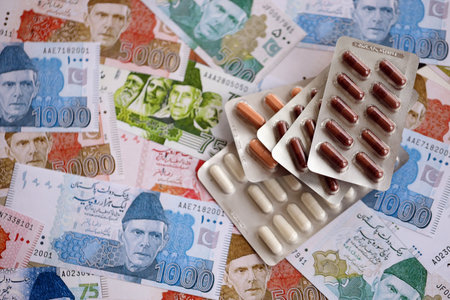Pakistan rupees banknotes and medicine pills. The current Pakistan money bills and drugs lies on table in big amount. The concept of medicine and pharmacy in Pakistanの写真素材