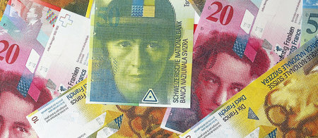 Swiss franc banknotes. The current francs money bills lies on table in big amount. The concept of...