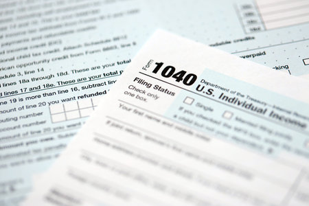 1040 US individual income tax return form blank close up. Few pages of united states tax blank. Concept of taxpaying and accounting in United Statesの写真素材
