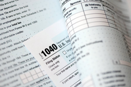 1040 US individual income tax return form blank close up. Few pages of united states tax blank. Concept of taxpaying and accounting in United Statesの写真素材