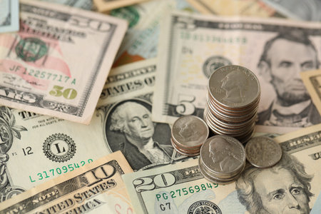 American US dollars money bills with coins and constitution close up on american flag. The American Recovery and Reinvestment Act Government Conceptの写真素材