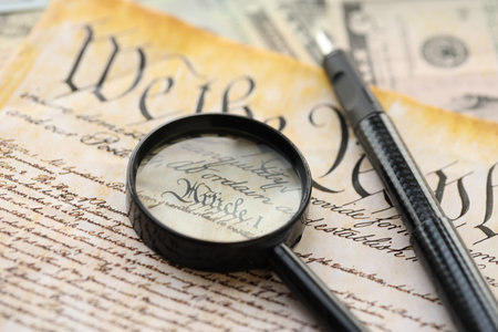 American USA Constitution paper page and magnifying glass close up. We The Peopleの写真素材