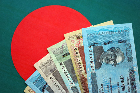 Bangladeshi taka money bills in big amount lies on Bangladesh flag close up. Finance and banking conceptの写真素材