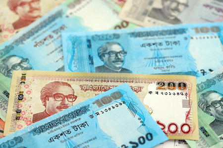 Bangladeshi taka money bills in big amount lies on white color table close up. Finance and banking conceptの写真素材