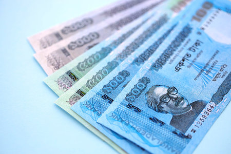 Bangladeshi taka money bills in big amount lies on teal color table close up. Finance and banking conceptの写真素材