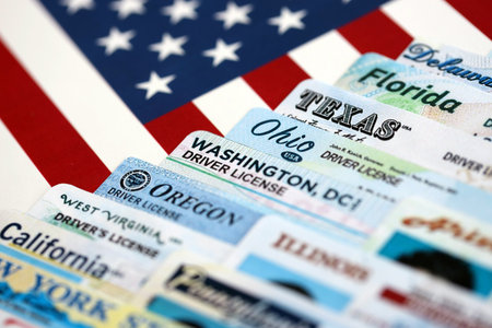 Big amount of driving licenses from different USA states on flag close up. Stack of driving license specimen cardsの写真素材