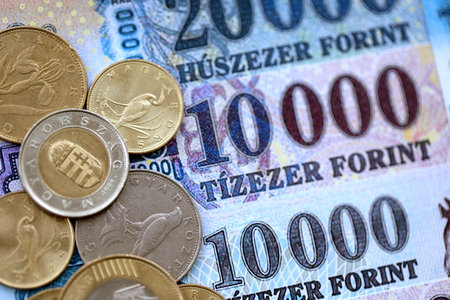 Heap of Hungarian Forint currency money bills and coins. HUF currency banknotes and coins close up