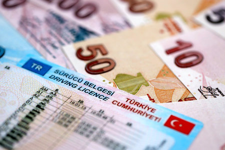 Turkiye driving permit concept. Driver license and turkish liras money bills close upの写真素材
