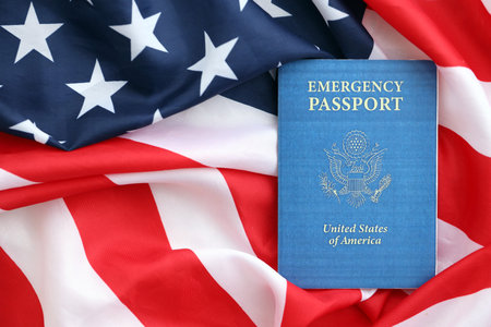 United States emergency passport book on US flag close up. Travel document on official banner photoの写真素材