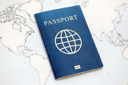 Generic Passport lies on world map close up. Concept of travel and tourism around the world