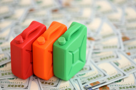 Petroleum canister lies on big amount of dollar bills. Concept of petrol prices in United Statesの写真素材