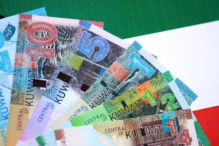 Kuwaiti dinar currency money bills lies on flag close up. The concept of business and investment