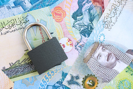 Bahraini dinar currency money bills and padlock close up. The concept of sanctions and financial...