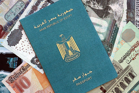 Egyptian pound currency money bills and passport close up. The concept of travel and vacationの写真素材
