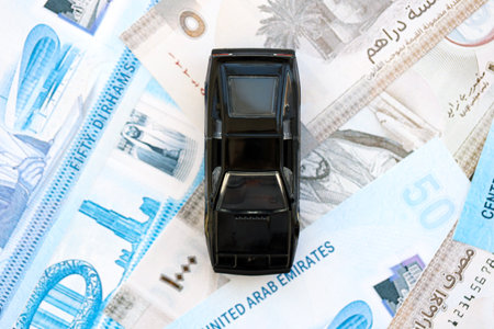 United Arab Emirates dirham currency money bills and toy car close up. The concept of car ownershipの写真素材