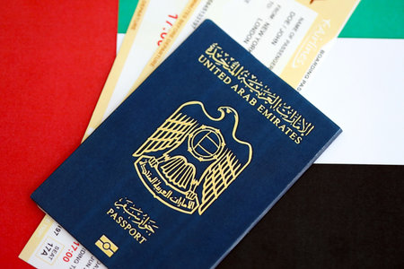 United Arab Emirates passport and boarding pass tickets on flag close up. The concept of travel and vacationの写真素材