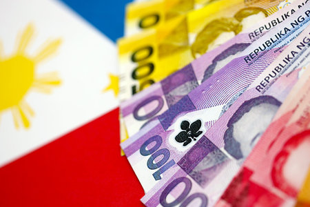 Philippines peso currency money bills lies on flag close up. The concept of business and investmentの写真素材