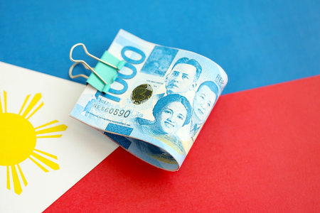 Philippines peso currency money bills lies on flag close up. The concept of business and investmentの写真素材