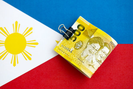 Philippines peso currency money bills lies on flag close up. The concept of business and investmentの写真素材