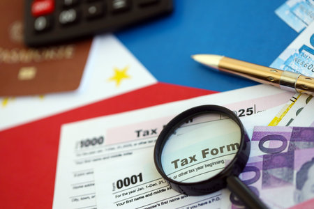 Philippines peso money bills and calculator with tax form on flag close up. Taxation and accounting conceptの写真素材