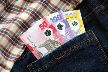 Philippines peso money bills in denims pocket close up. The concept of fashion and wealthの写真素材