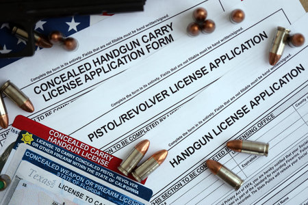 USA firearms license and handgun with bullets on US Constitution. Gun permit and Constitution second amendment conceptの写真素材