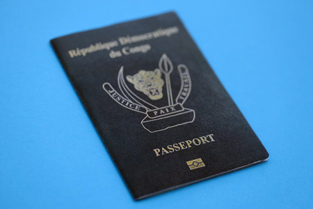 Democratic Republic of Congo black passport on light blue table background close up. Concept of travel and tourismの写真素材