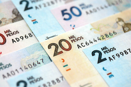 Colombian pesos money bills banknotes lies in big pile on table close up. Concept of finances and business in Colombiaの写真素材