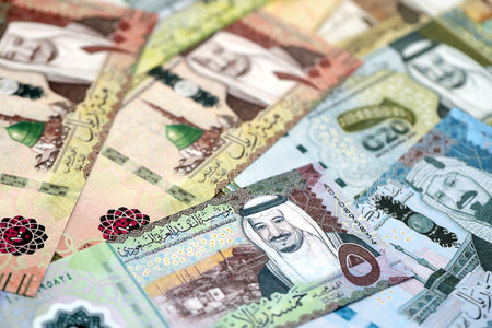 Saudi Arabia riyal money bills banknotes lies in big pile on table close up. Concept of finances and business in Saudi Arabiaの写真素材