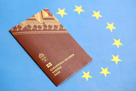 Swedish biometrical passport on European Union flag background. Concept of citizenship of Swedenの写真素材