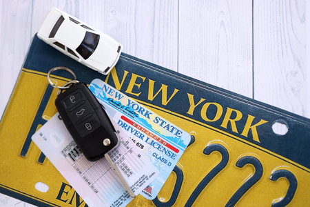 Remote control car keys on New York license plate with driver license. Concept of driving in New York. Reaching a driving permitの写真素材