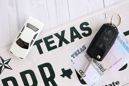 Remote control car keys on Texas license plate with driver license. Concept of driving in Texas. Reaching a driving permitの写真素材