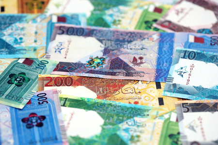 Qatari riyal money bills banknotes lies in big pile on table close up. Concept of finances and...