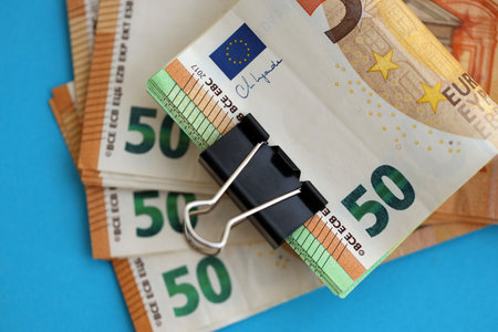 Big amount of european euro currency money notes on blue color table close up. Concept of business and income in Europeの写真素材