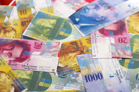 Swiss franc banknotes. The current francs money bills lies on table in big amount. The concept of business and investmentの写真素材