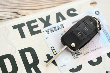 Remote control car keys on license plate with driver license. Concept of driving in Texas. Reaching a driving permitの写真素材