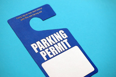 Parking permit paper notice tag for car interior close up. Parking permit for people with disabilities concept. Private parkingの写真素材
