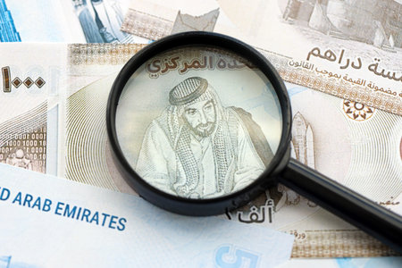 United Arab Emirates dirham currency money bills and magnifying glass close up. The concept of financial monitoring and taxationの写真素材