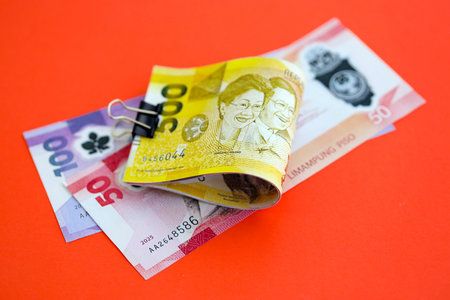Philippines peso money bills in big amount close up on red. Finance and banking conceptの写真素材