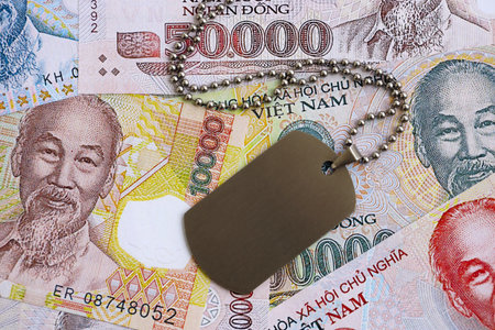 Vietnamese dong currency money bills and military token close up. The concept of army serviceの写真素材