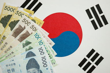 South Korean won money bills in big amount lies on South Korea flag close up. Finance and banking conceptの写真素材
