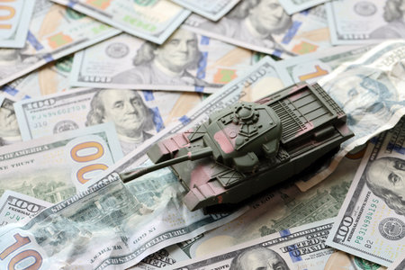 Tank on crumpled hundred dollar bills banknotes. Background of war funding and military support price for United States of Americaの写真素材