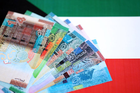 Kuwaiti dinar currency money bills lies on flag close up. The concept of business and investmentの写真素材