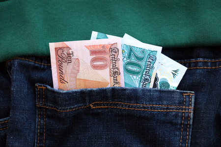 Egyptian pound money bills in denims pocket close up. The concept of fashion and wealthの写真素材