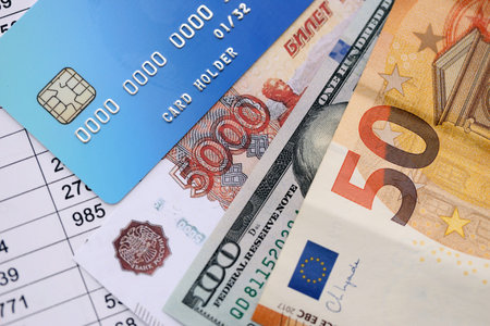 Credit card and russian rubles, euro and US dollar bills banknotes on calculations document...