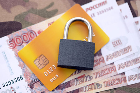 Russian rubles money bills and credit card under ban of heavy lockpad close up. Concept of sanctions and restrictions to russian citizensの写真素材