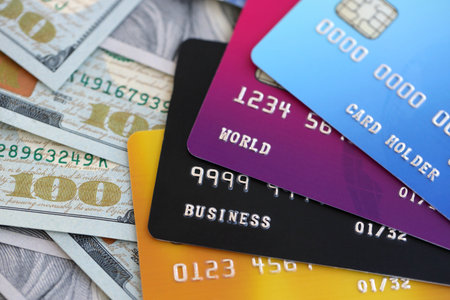 One hundred US dollar bill banknotes and credit cards for banking and payments. Concept of business and bank serviceの写真素材