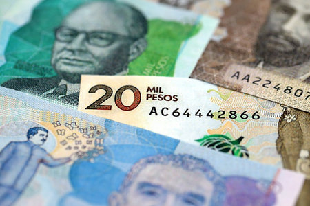 Colombian pesos money bills banknotes lies in big pile on table close up. Concept of finances and business in Colombiaの写真素材