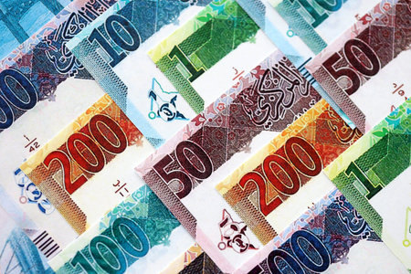 Qatari riyal money bills banknotes lies in big pile on table close up. Concept of finances and...