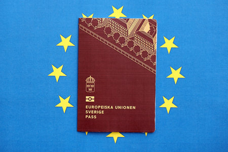 Swedish biometrical passport on European Union flag background. Concept of citizenship of Swedenの写真素材
